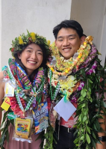 2 people wearing lei