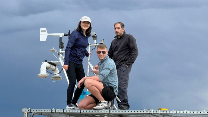 three people with dark cloud behind them