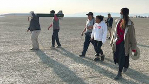 people carrying rocket