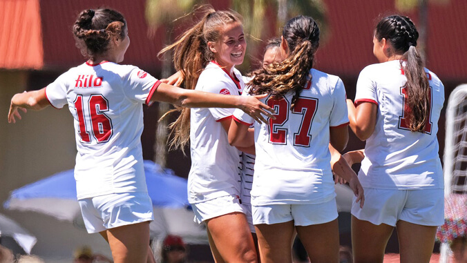 Soccer players celebrating and smiling