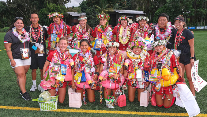Group of U H Hilo soccer seniors wearing lei