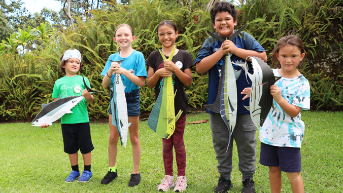 Five children holding crafts