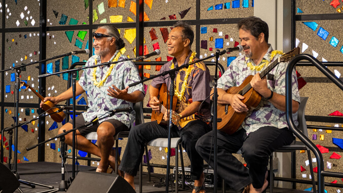 Three people holding instruments