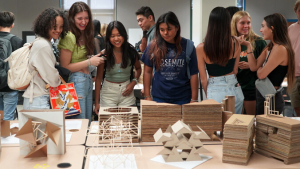 students viewing design pieces
