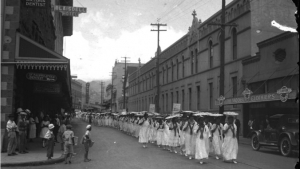 old photo of people walking through fort street