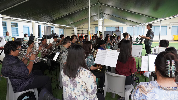 people sitting with instruments and playing