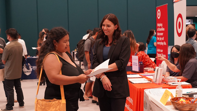 student talking with potential employer