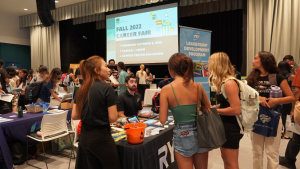 students talking with potential employer
