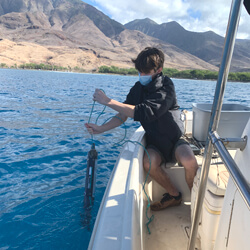 Person on a boat testing water sample