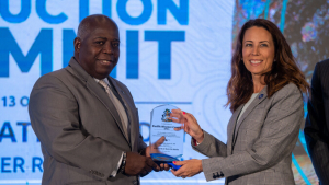 Two people holding a plaque