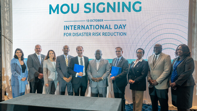 People standing in front of M O U signing screen