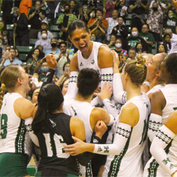 A group of volleyball players celebrating