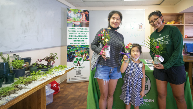 people holding flowers smiling