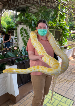 person holding a large snake