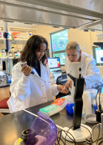 student and staff in lab