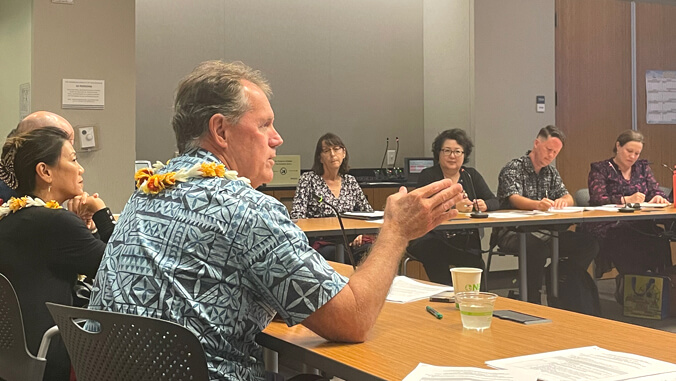 Ed Case speaking to a group of people