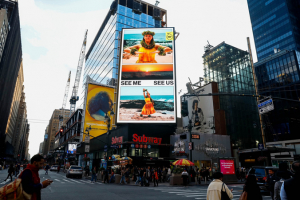 Street in New York City with a billboard featuring Lopes