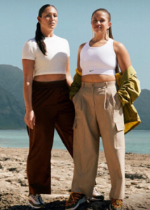 Two women standing outside near the ocean