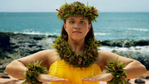 Woman in hula attire looking straight out
