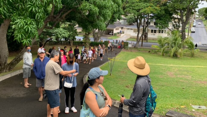 people standing in a line in a driveway