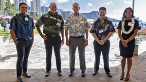 five people smiling