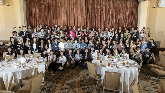 more than 100 people smiling for the camera