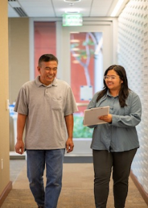 patient walking with a research associate