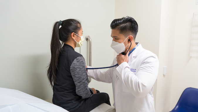 a doctor checks on a patient