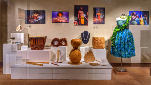 Display of Hawaiian instruments, clothing and photos from stage performances