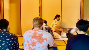 Person performing a tea ceremony with an audience
