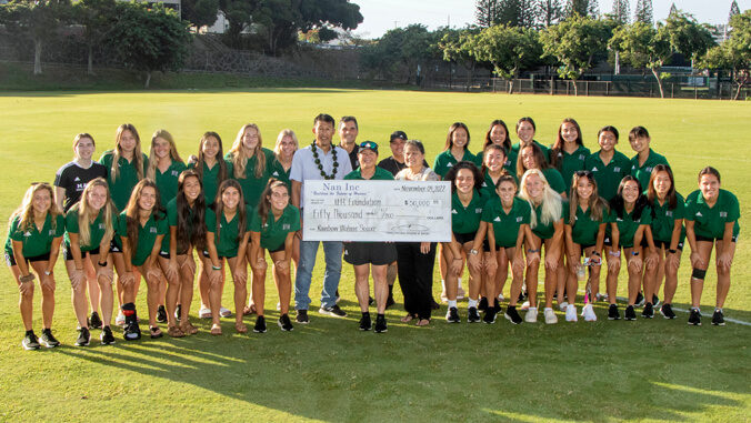 U H soccer team and donors with big check
