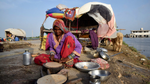 Woman cooking next to a river