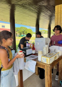 Student visiting a shave ice table