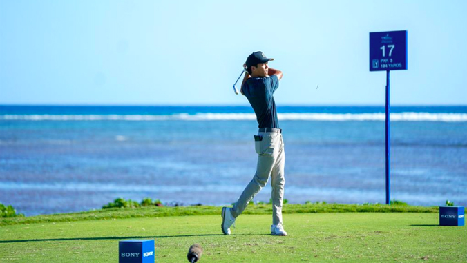 person with a golf club swinging