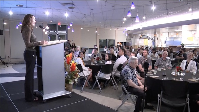 a med student addressing guests at the scholarship dinner