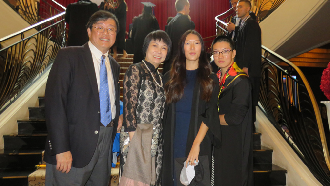 four people smiling at the camera