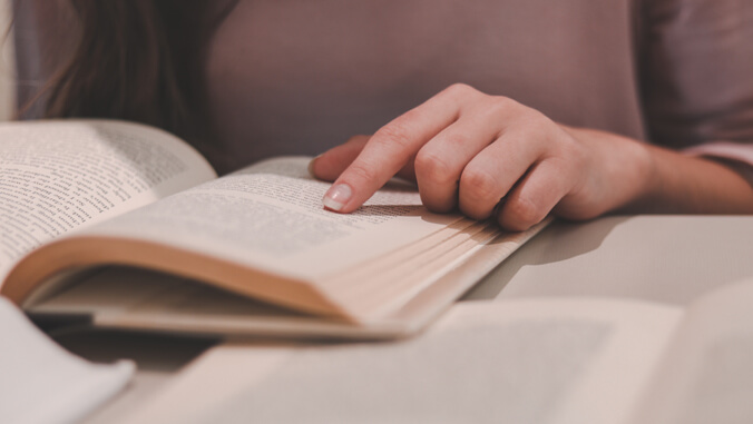 Person's hand on book