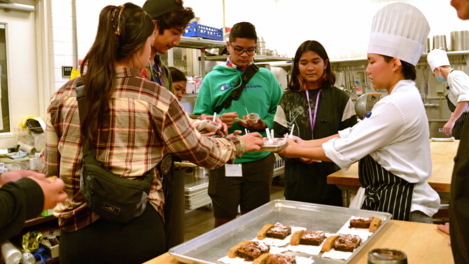high school students taking food sample in Kauai CC kitchen