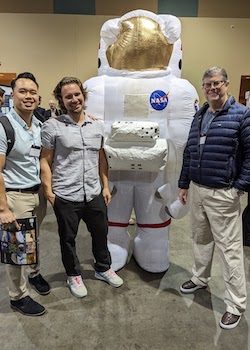 three people with astronaut