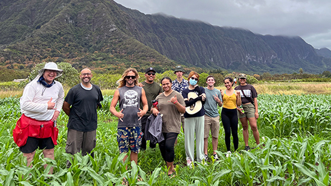 research students in a field where they gather agricultural data