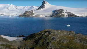 large body of water surrounded by ice and rock