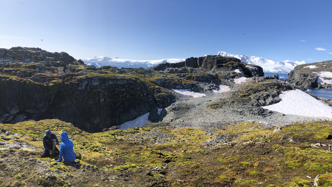 people sitting on rock surrounded by rock and ice