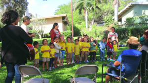 A group of children singing outside