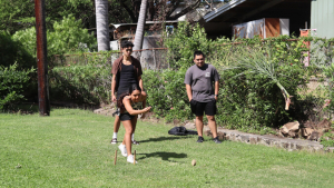 Three people playing a game outside