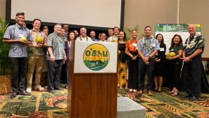 people smiling behind a podium