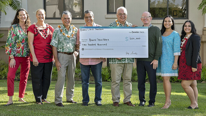 people holding big check
