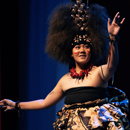 Woman dancer with arms raised in Samoan clothing