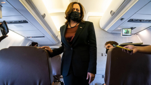 Kamala Harris walking down an airplane aisle