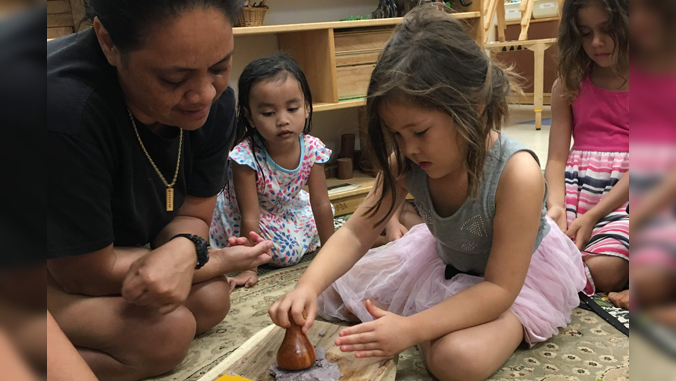 children making poi with teacher