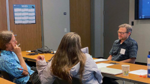 People having a discussion around a table